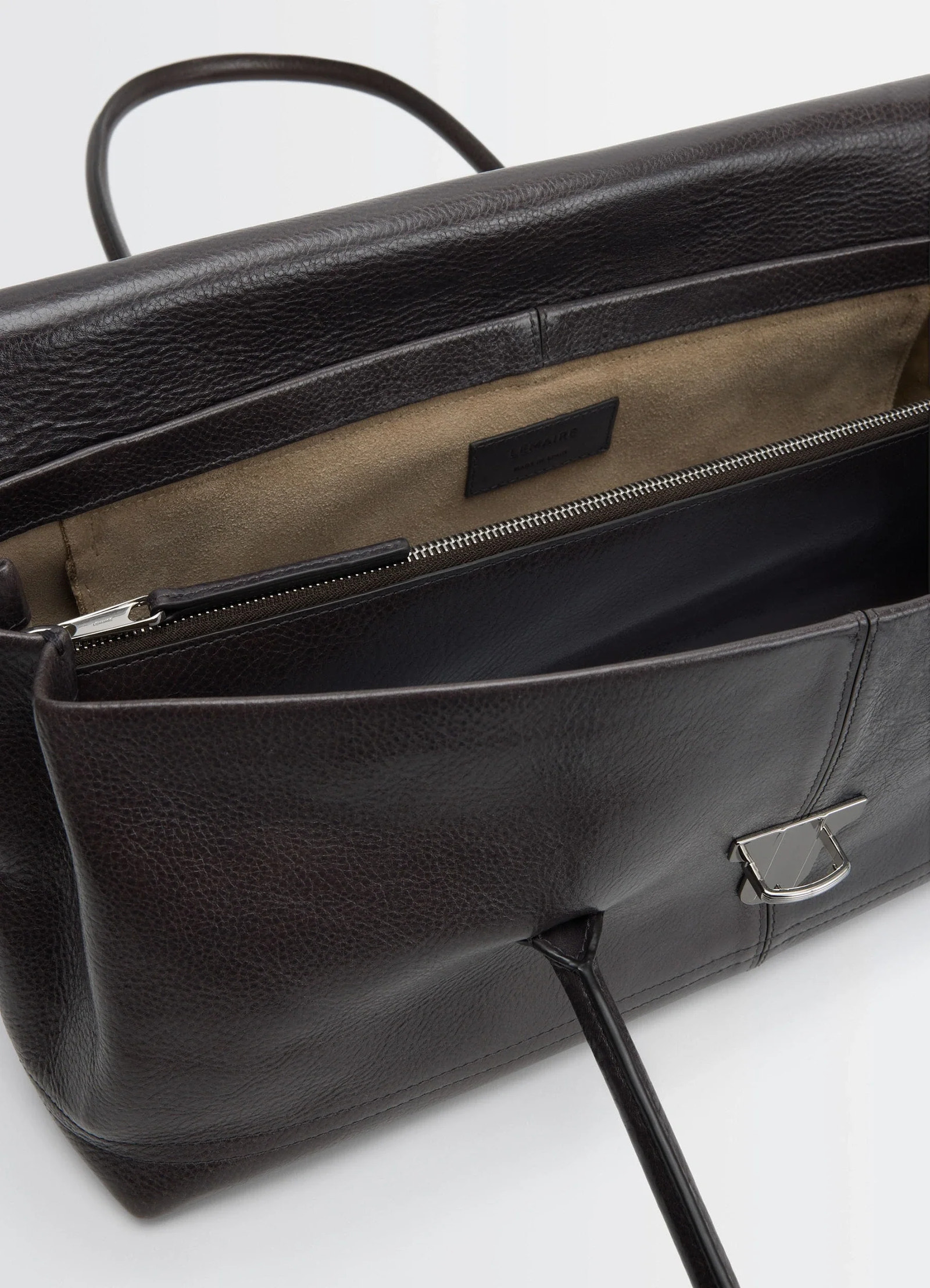 Lemaire shoulder gear bag in glossy vegetable-tanned leather, product shot, interior view open top zipper detail
