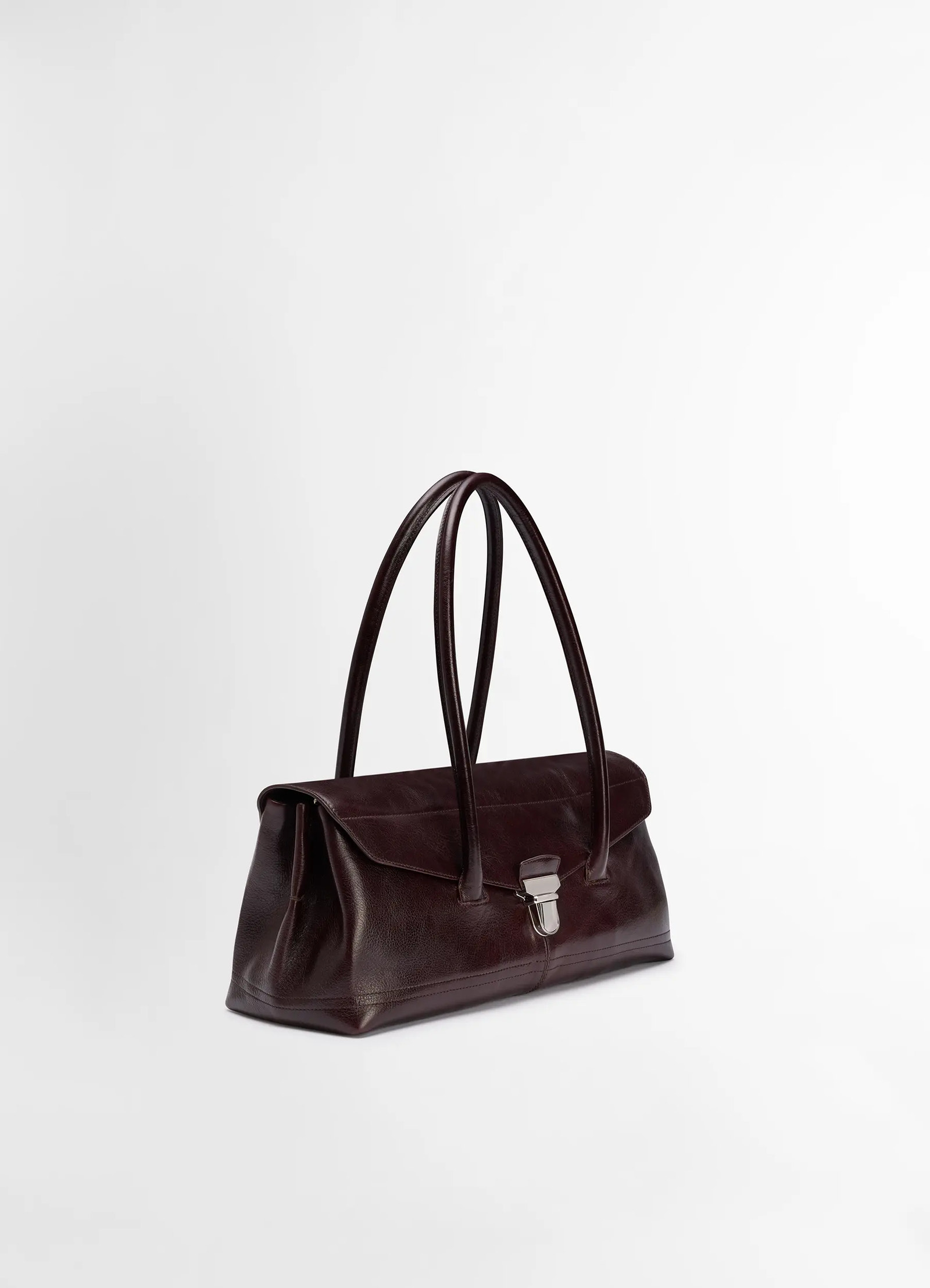 Lemaire shoulder gear bag in glossy vegetable-tanned leather, product shot, three-quarter view double strap design