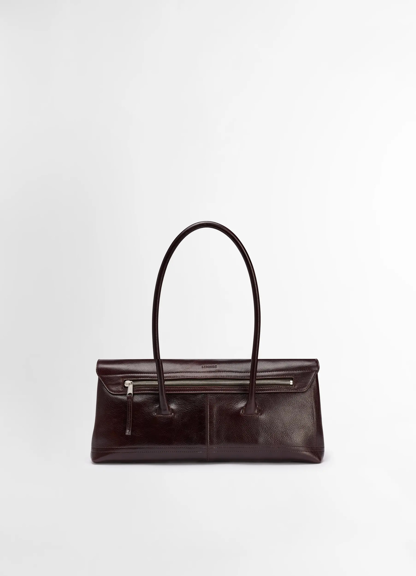 Lemaire shoulder gear bag in glossy vegetable-tanned leather, product shot, top front view long handle design