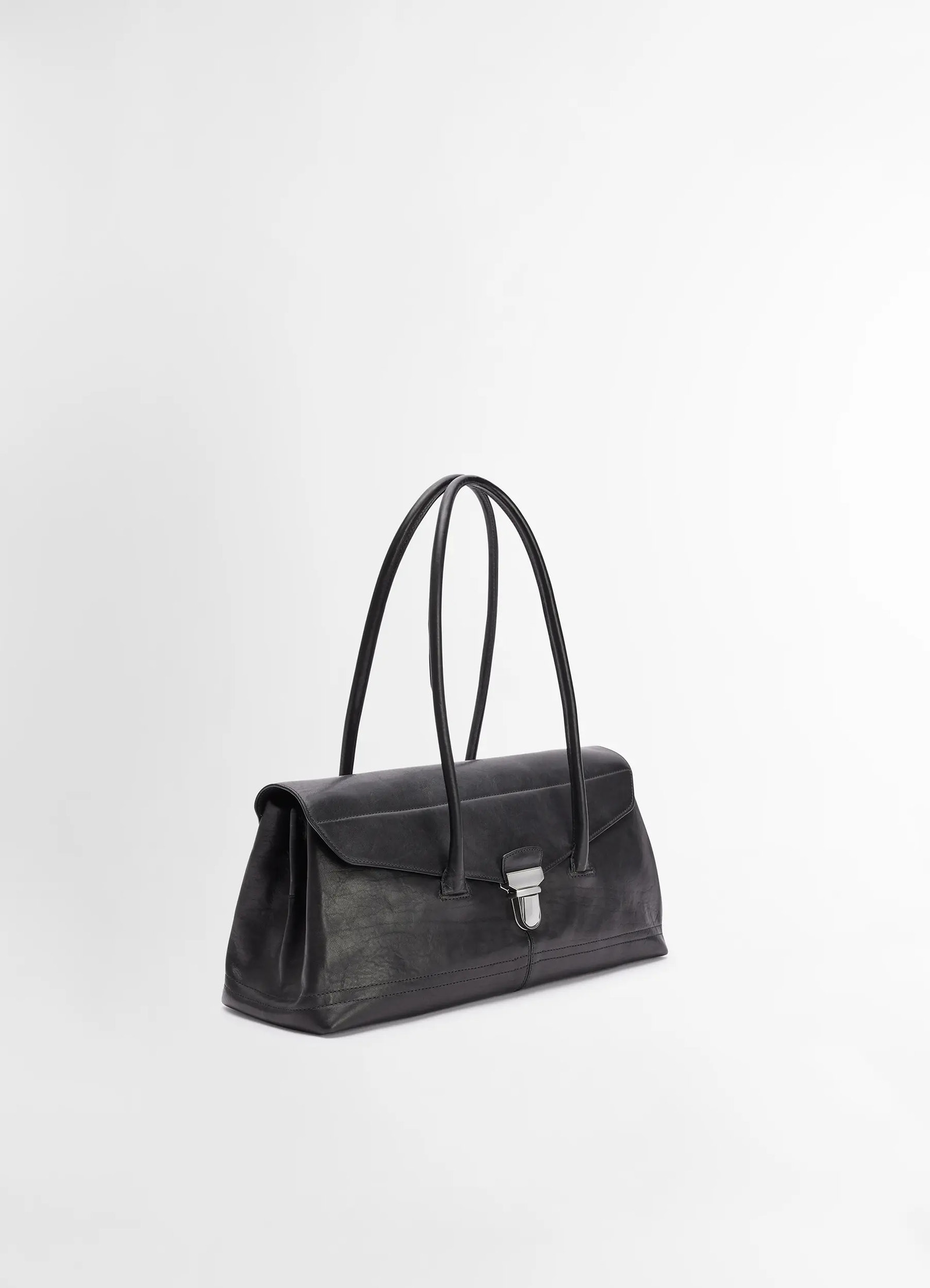 Lemaire shoulder gear bag in black vegetable tanned nappa, product shot, three-quarter view elegant curved handles