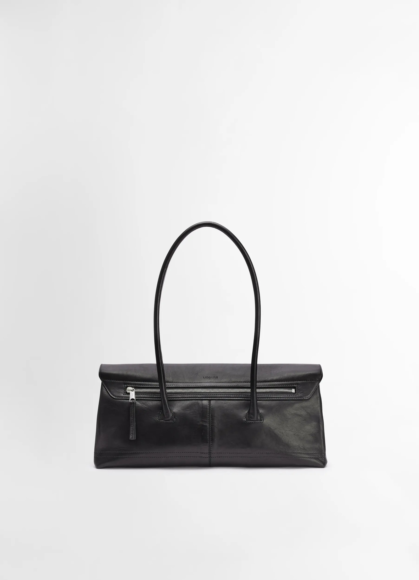Lemaire shoulder gear bag in black vegetable tanned nappa, product shot, top view minimalist zippered front