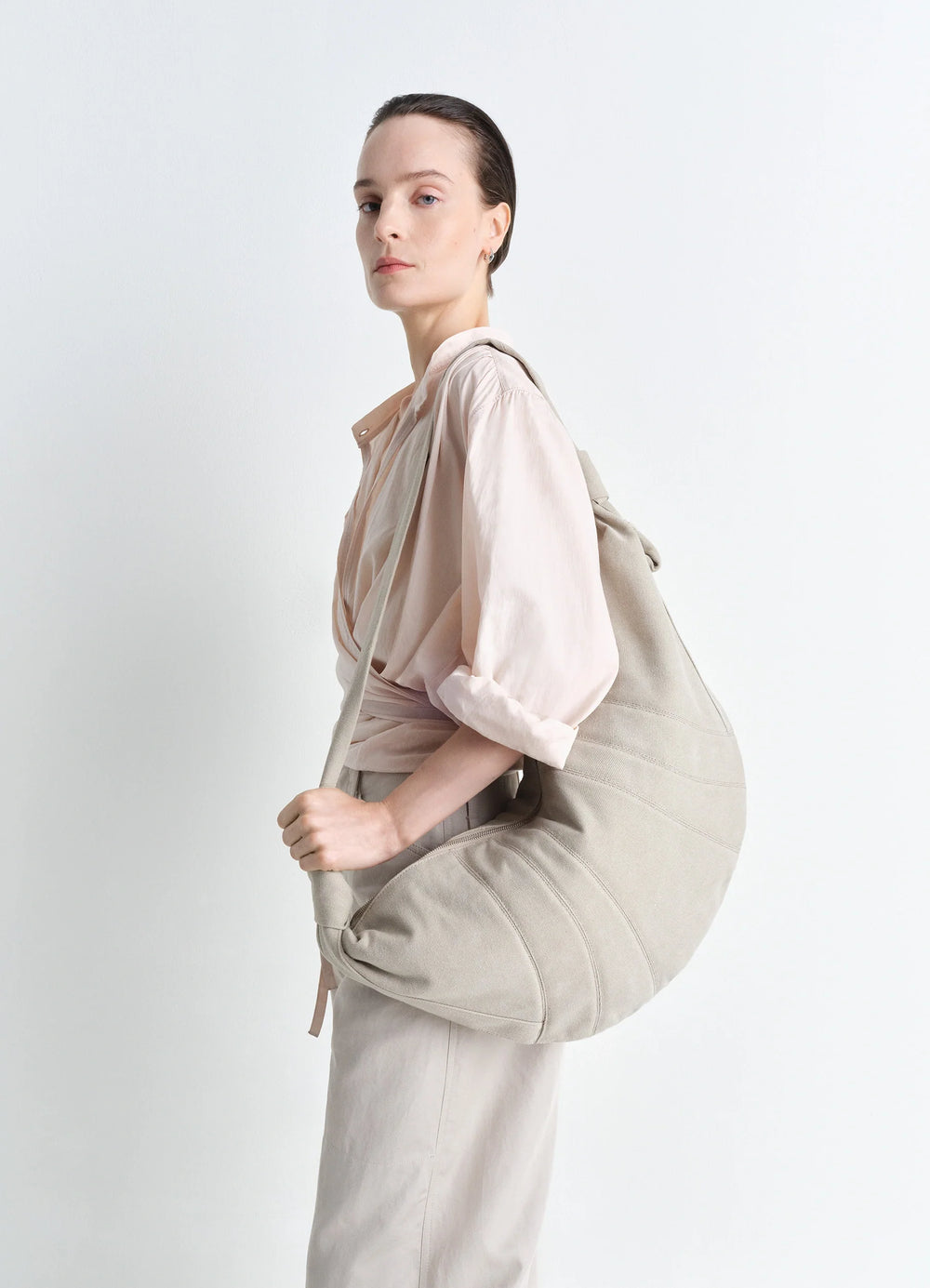 XL Croissant Bag in Heavy Cotton Canvas, model shot, three-quarter view minimalist shoulder carry
