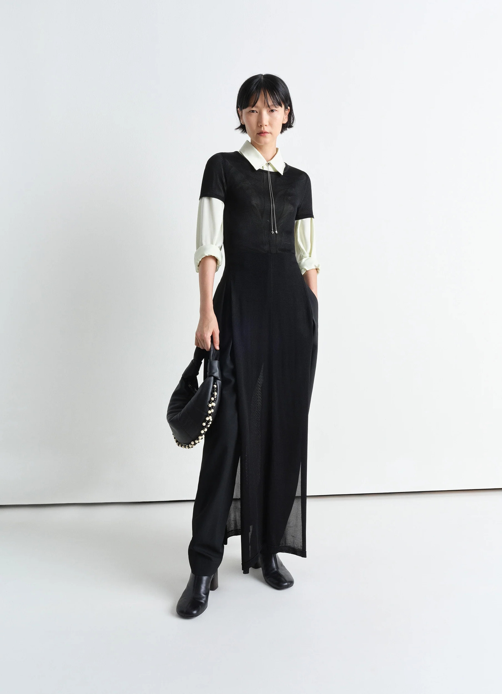 Mini fortune bag with beads in soft nappa lamb leather, model shot, side view bag held by hand