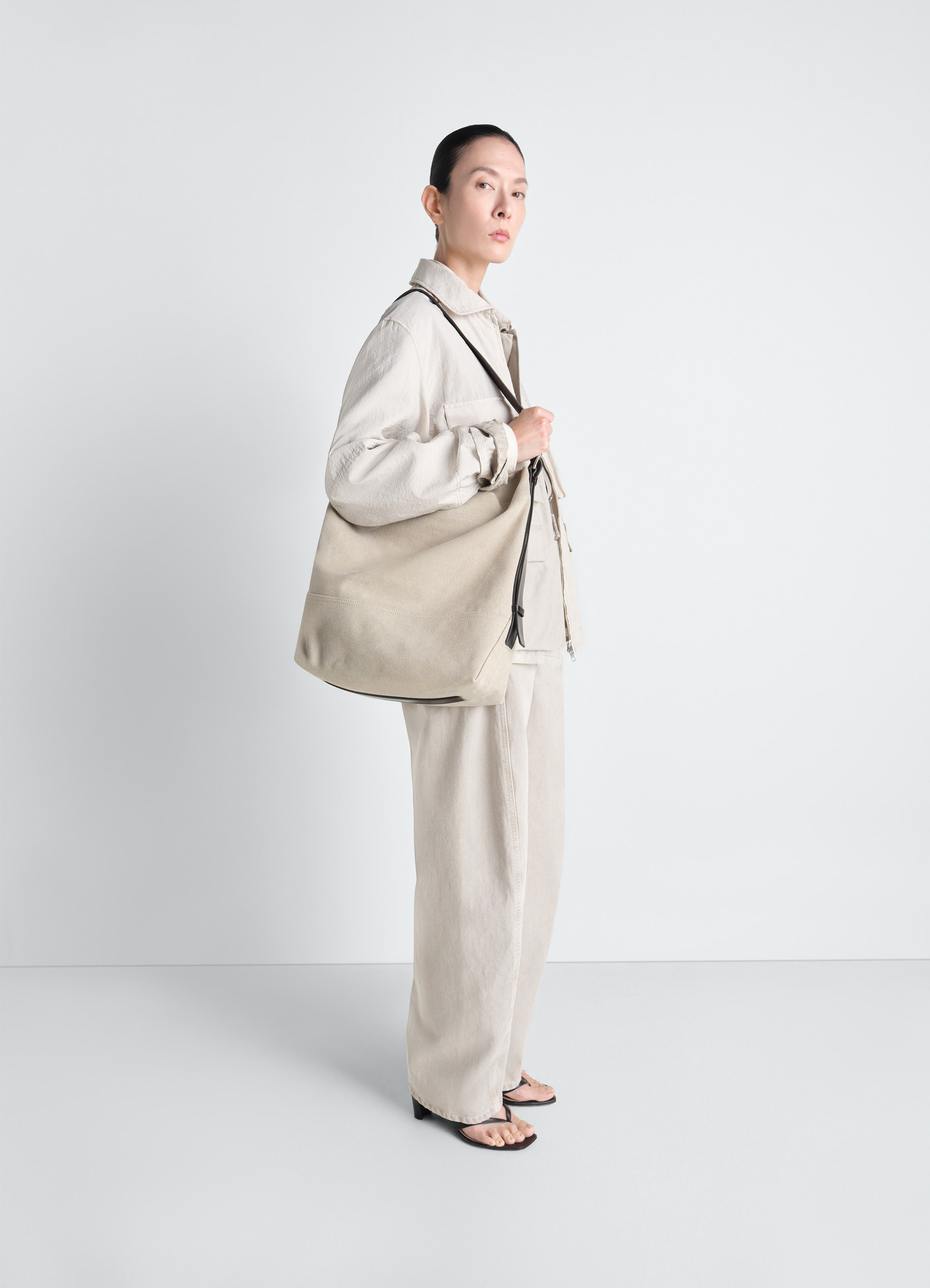 Belted tote bag in cotton canvas, model shot, three-quarter view oversized shape