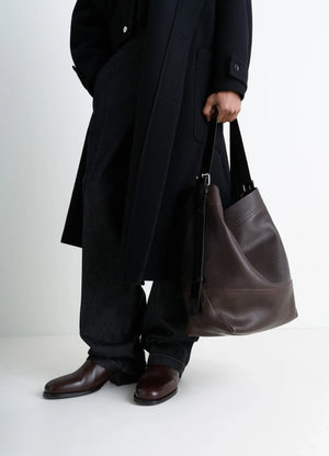 Belted Tote Bag in LWG Gold-certified grained leather, model shot, side view worn by model with dark coat