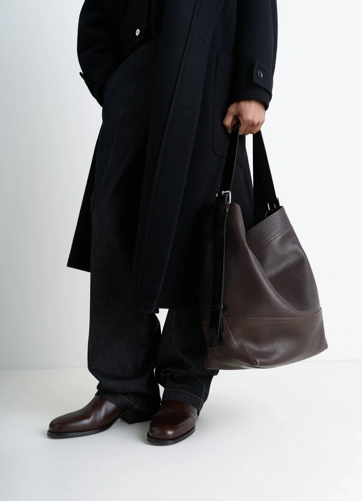 Belted Tote Bag in LWG Gold-certified grained leather, model shot, side view worn by model with dark coat