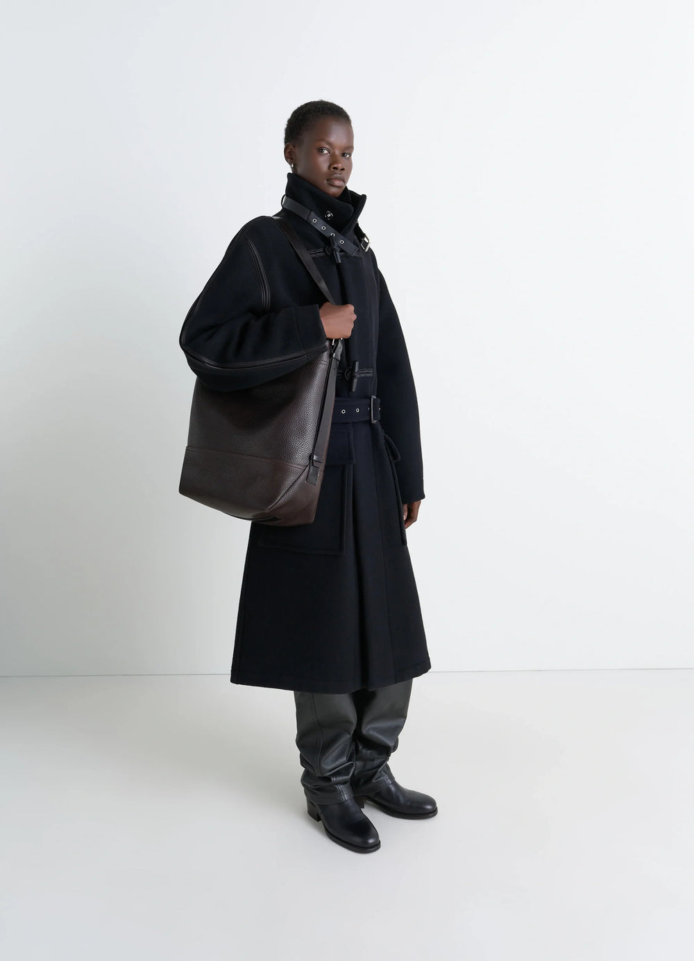 Belted Tote Bag in LWG Gold-certified grained leather, model shot, three-quarter view worn by model with boots