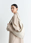 Lemaire Scarf Bag Small in Smooth Nappa Leather, model shot, Side view Twisted handle worn cross-body
