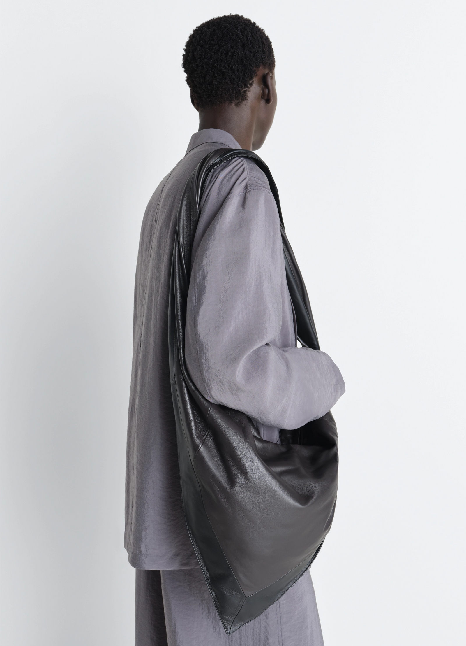 Lemaire scarf bag in nappa leather, model shot, back view draped over shoulder