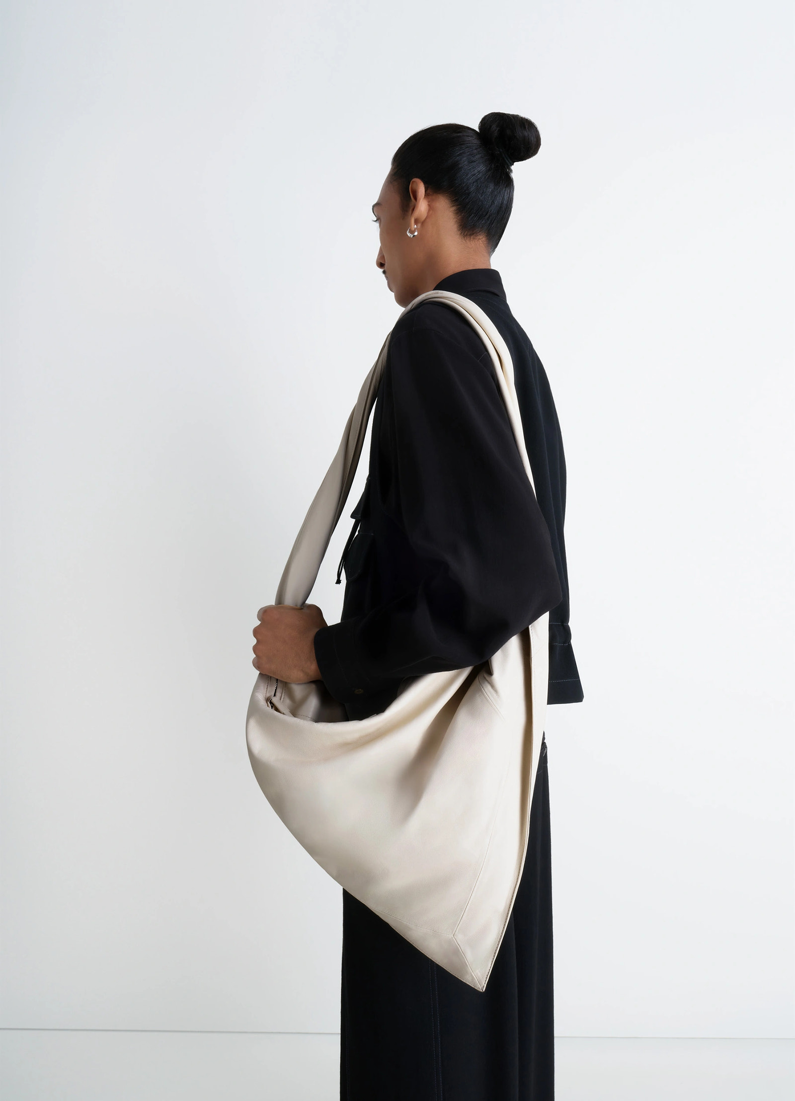 Lemaire scarf bag in nappa leather, model shot, side view twisted strap