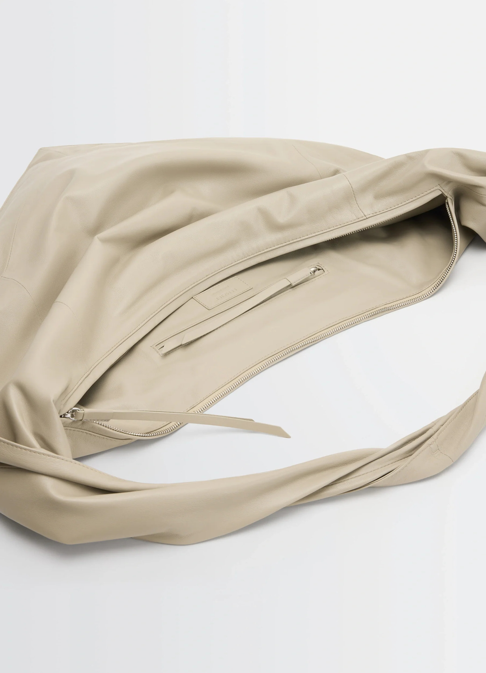 Lemaire scarf bag in nappa leather, product shot, top interior view zippered pocket detail