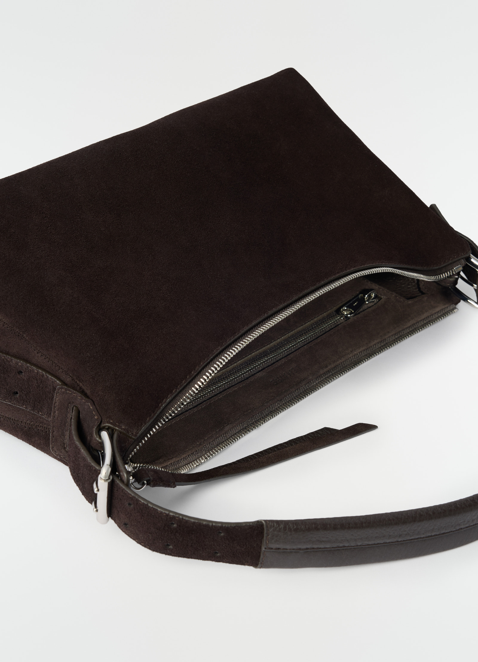 Belted baguette bag lemaire in dark brown suede leather with silver zipper close-up detail on plain white background