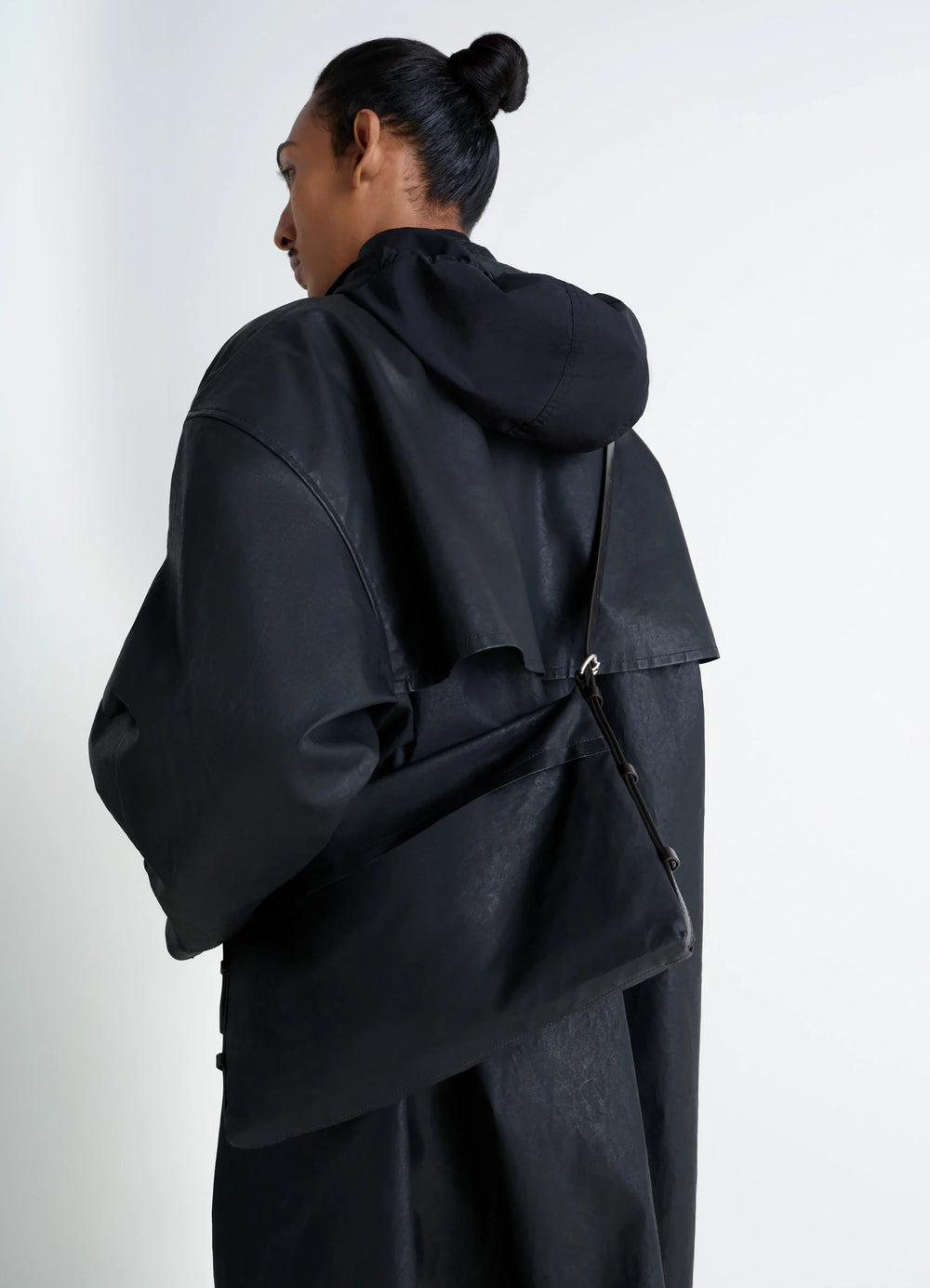 Trench Pocket Small Bag in GOTS-certified resinated cotton, model shot, back view minimalist single strap