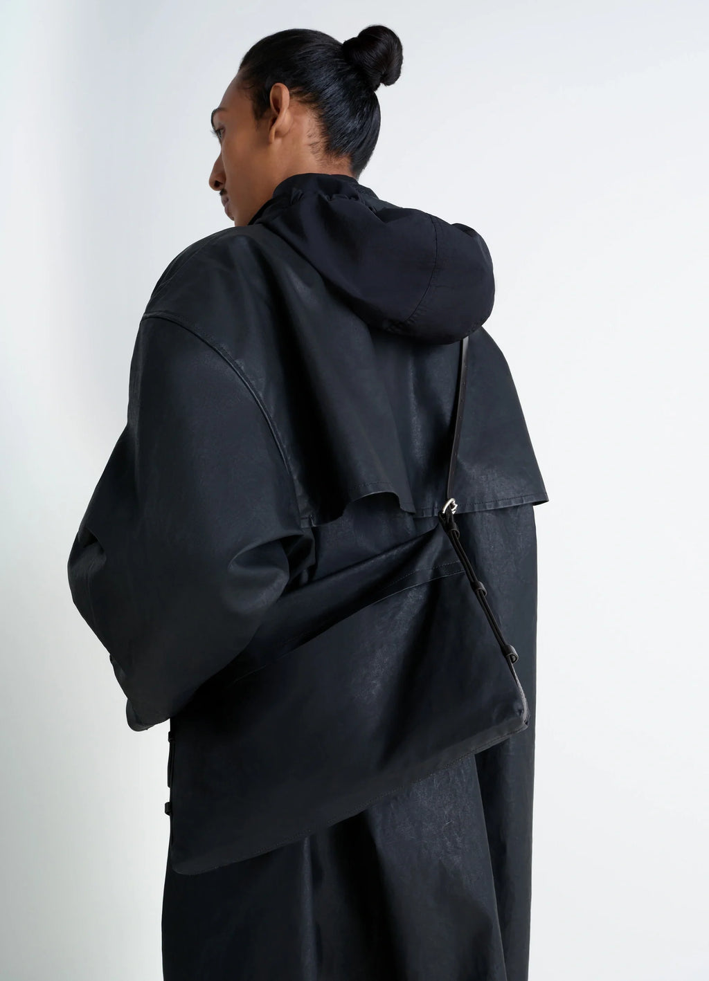 Trench Pocket Small Bag in GOTS-certified resinated cotton, model shot, back view minimalist single strap