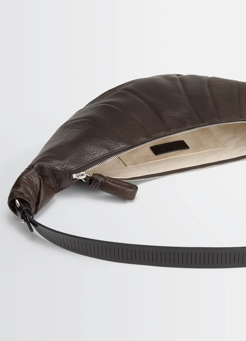 Rail Belt Medium Croissant Bag in Grained Leather in Brown, product shot, interior detail shot zippered opening with tag