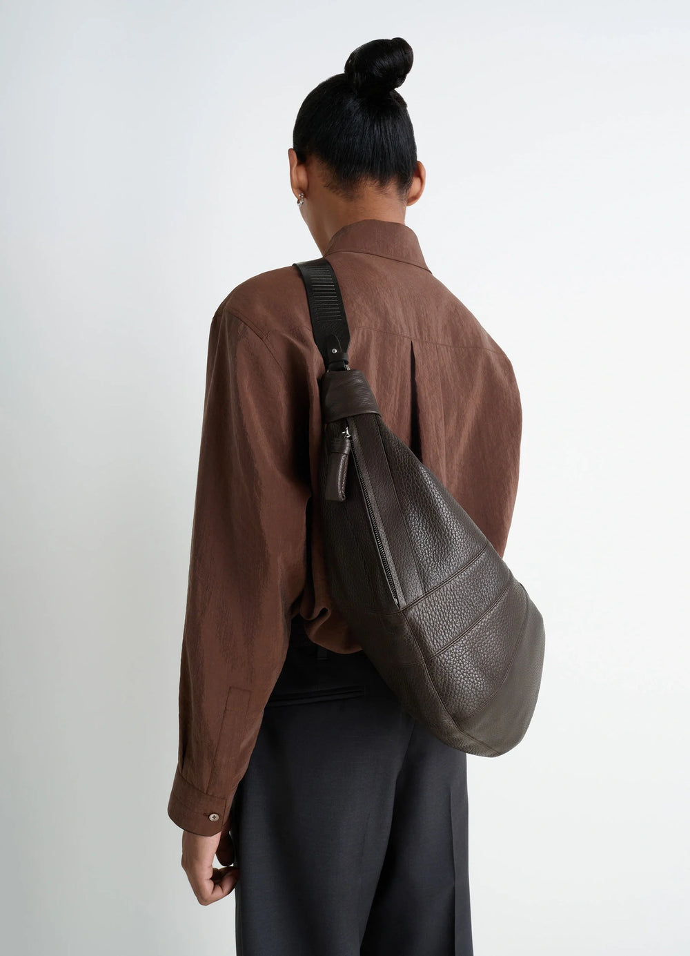 Lemaire Rail Belt Large Croissant B in Grained Leather, model shot, back view textured grained leather