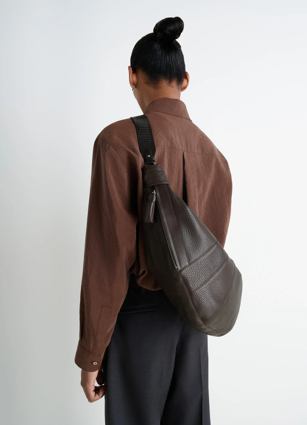 Lemaire Rail Belt Large Croissant B in Grained Leather, model shot, back view textured grained leather