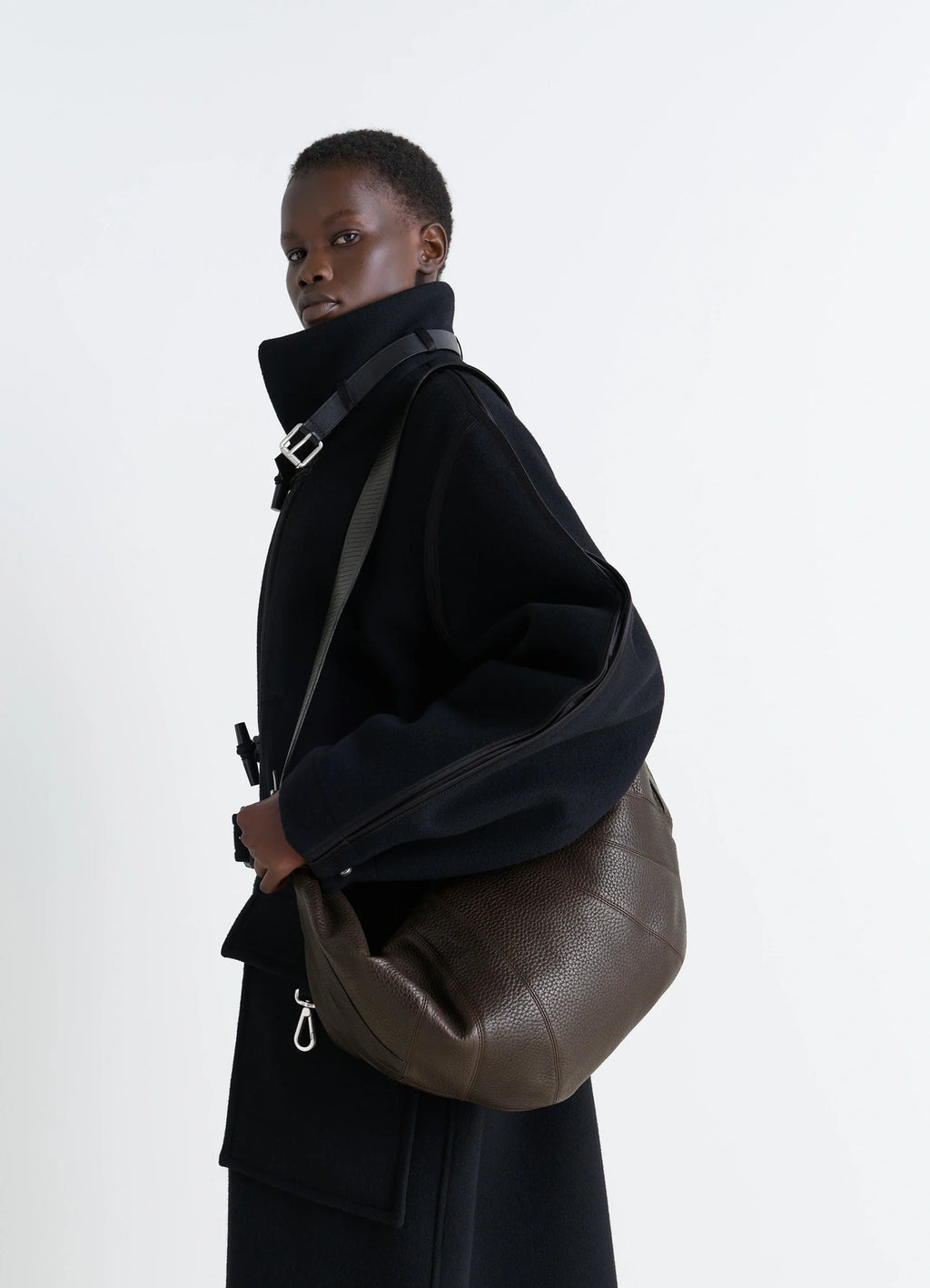 Lemaire Rail Belt Large Croissant B in Grained Leather, model shot, Side View Curved Design