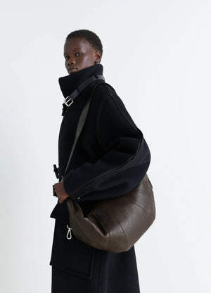 Lemaire Rail Belt Large Croissant B in Grained Leather, model shot, Side View Curved Design