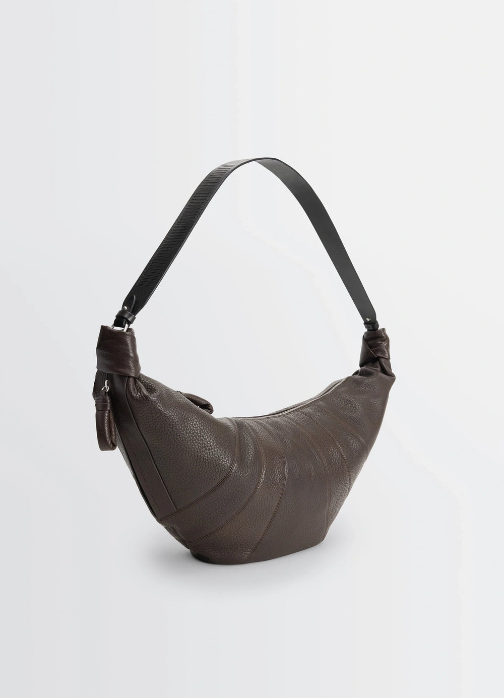 Lemaire Rail Belt Large Croissant B in Grained Leather, product shot, three-quarter view asymmetrical strap detail