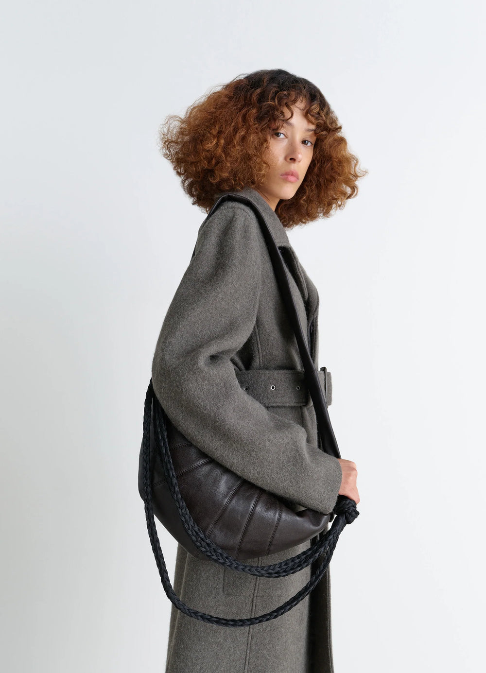 Lemaire Braid Medium Croissant Bag in Grained Buffalo Leather, model shot, Side view Braided shoulder straps