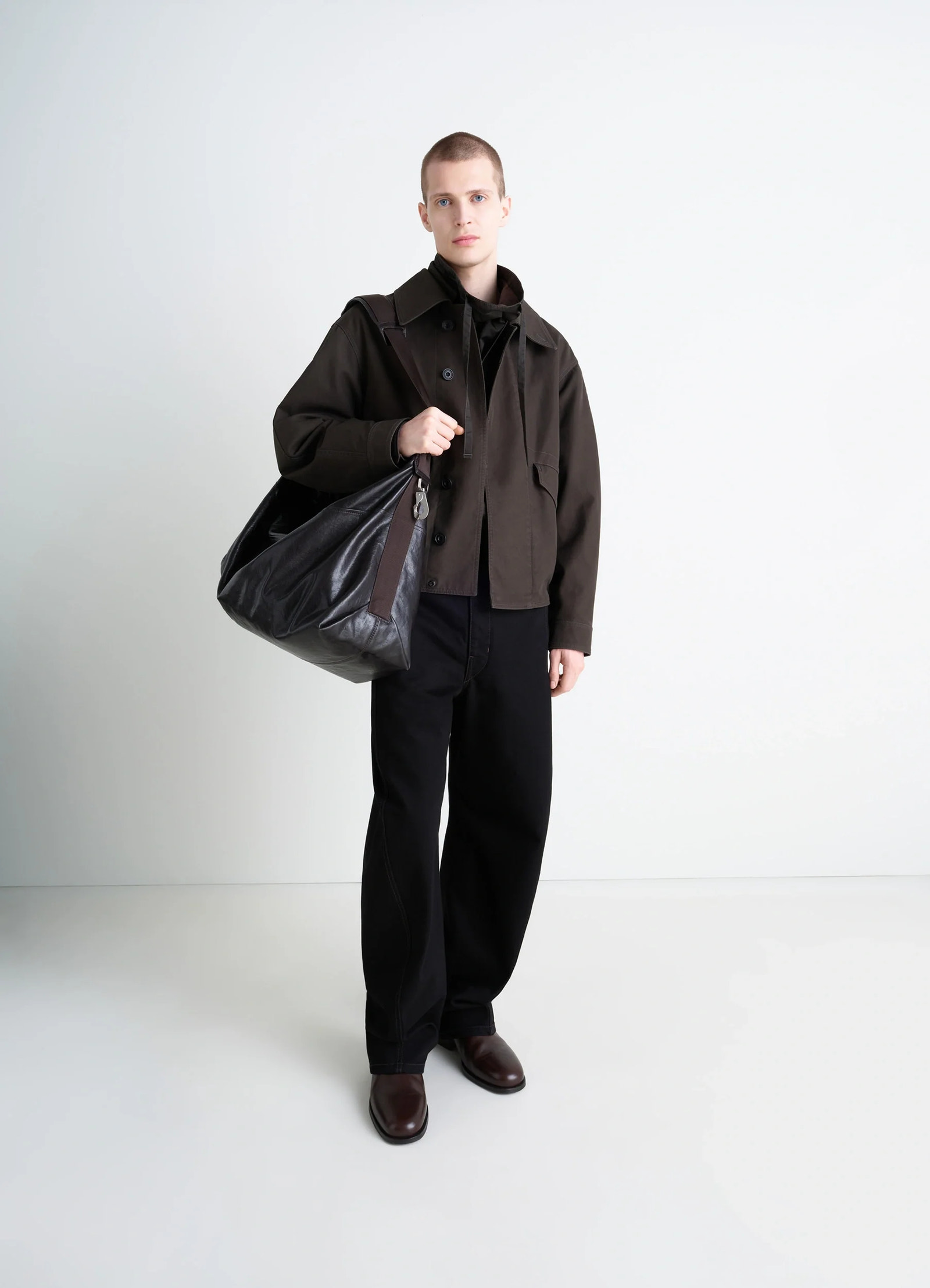 Berlingot 72h weekend bag in glazed paper leather, model shot, held over shoulder casual chic appearance