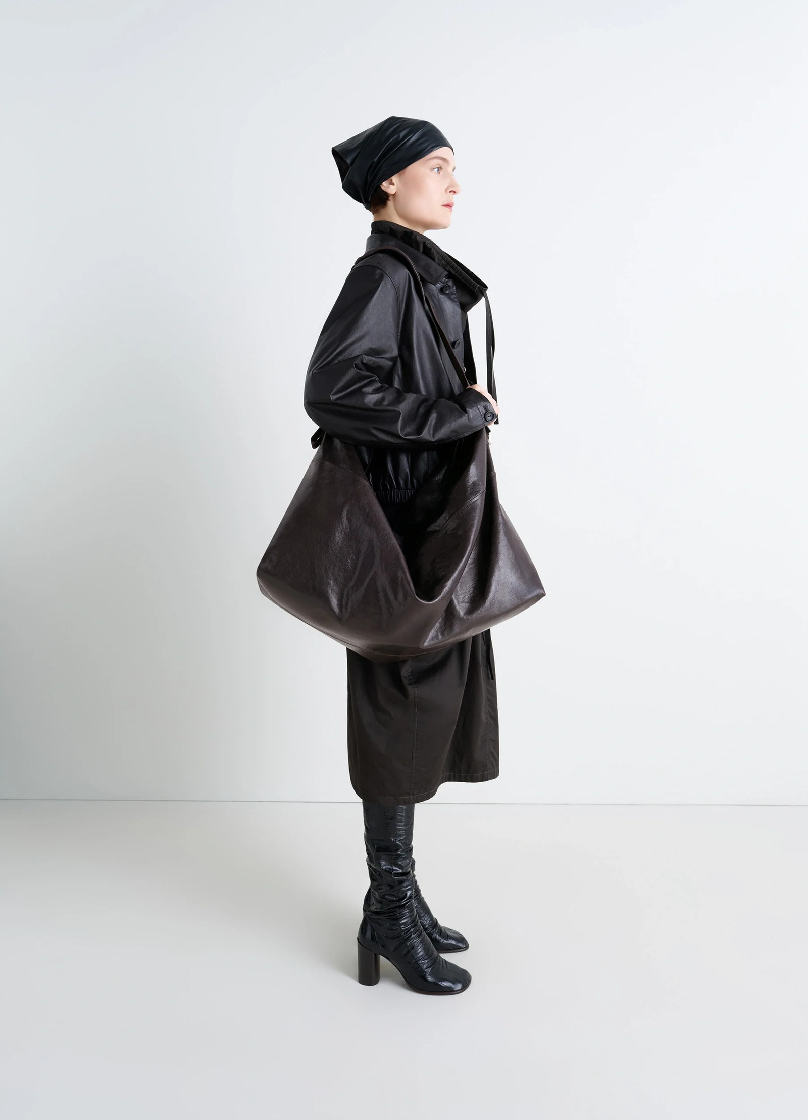 Berlingot 72h weekend bag in glazed paper leather, model shot, side view minimalist and versatile