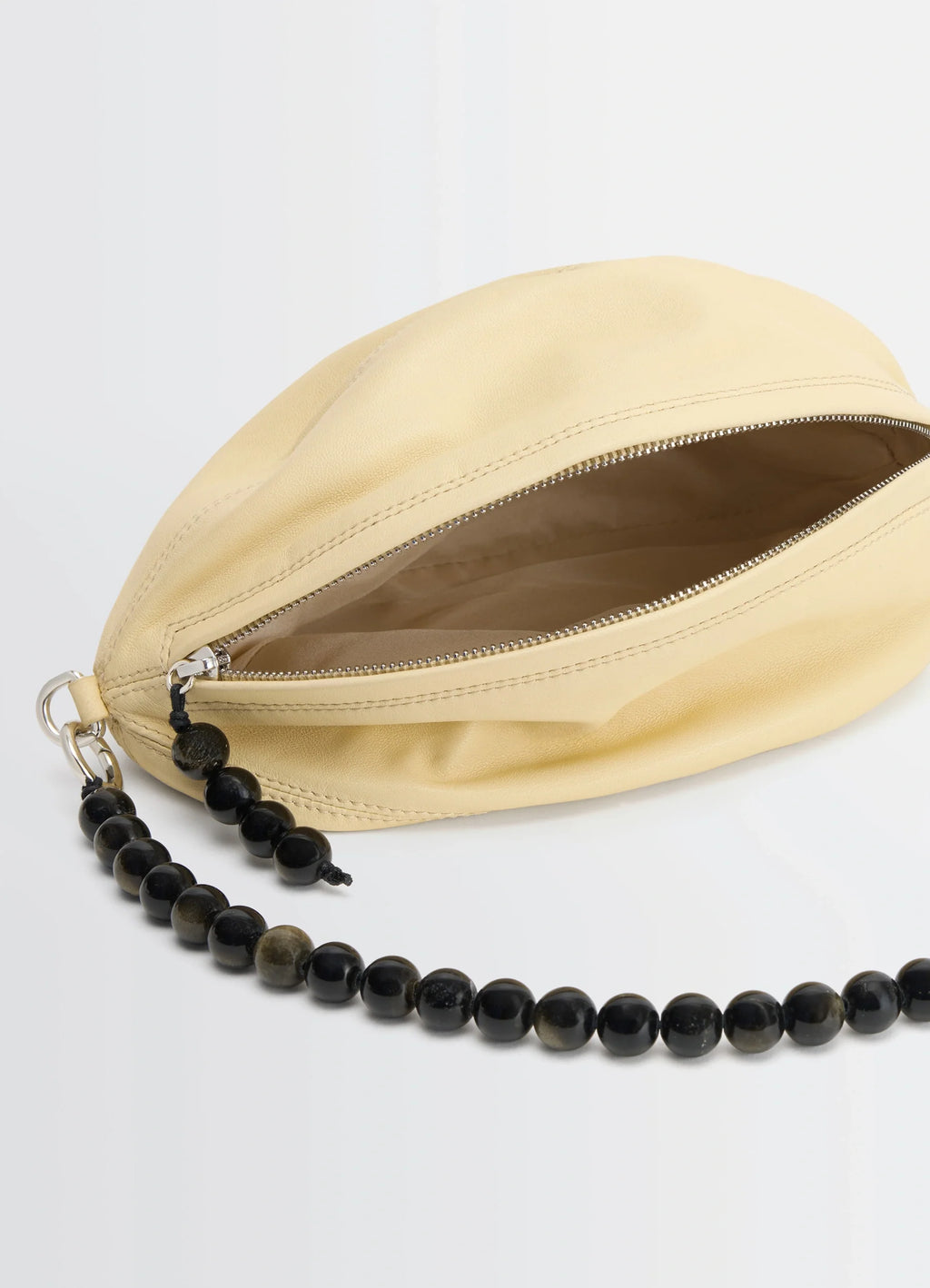 Balloon Pouch by Lemaire in LWG Silver nappa lamb leather, product shot, detail open zipper angle visible interior with beads