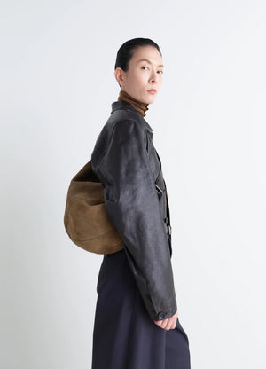 Lemaire Quiver Clip Bag in Warm LWG Gold suede, model shot, Side view Worn crossbody