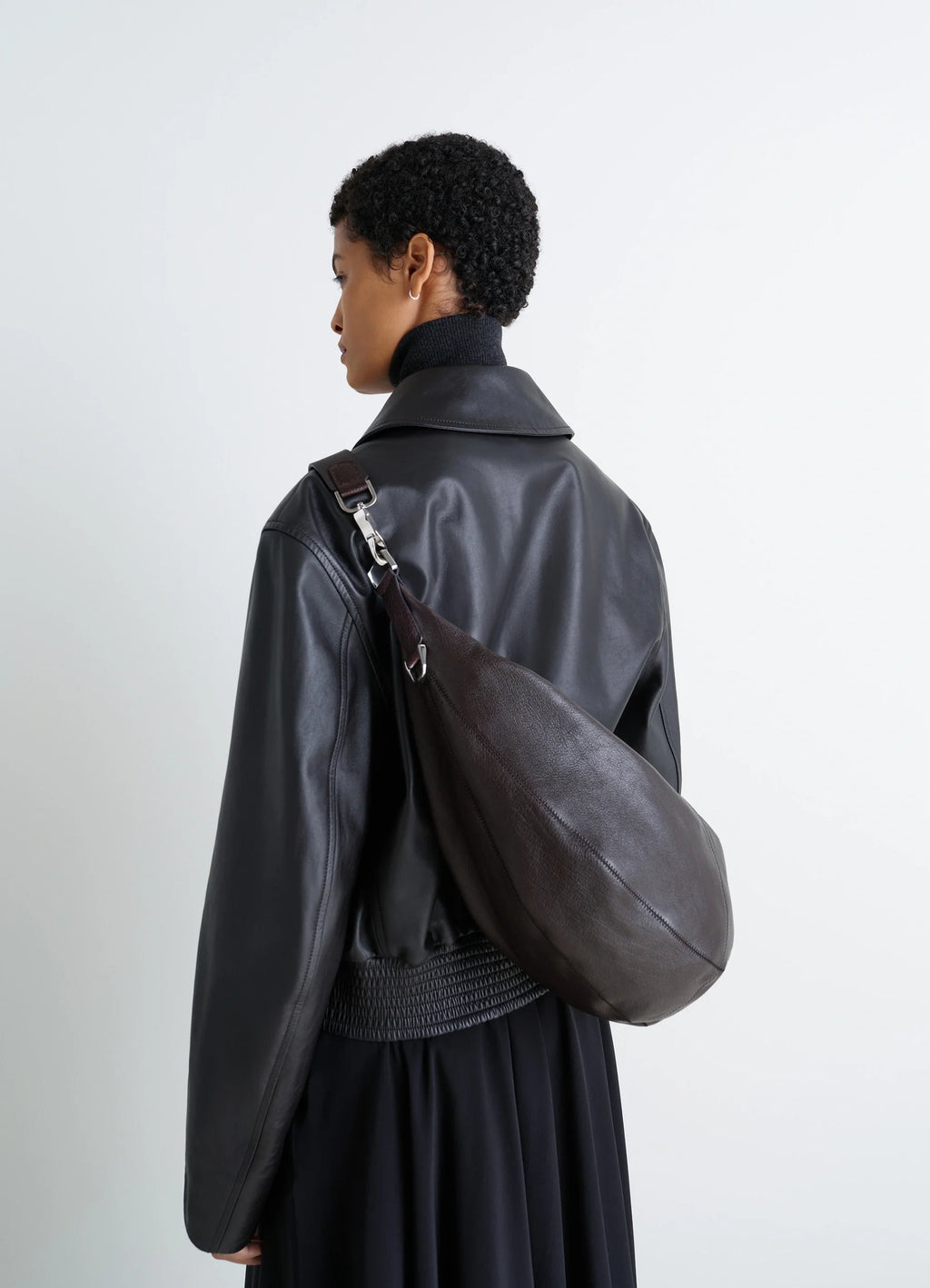 Lemaire Quiver Clip Bag in Grained Buffalo Leather, model shot, Back view Crossbody worn