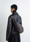 Lemaire Quiver Clip Bag in Grained Buffalo Leather, model shot, Back view Crossbody worn