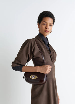 AUBOCK EYE BAG in Brown Leather, model shot, Front side view Surreal eye-shaped buckle