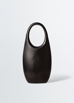Carlos peñafiel black leather naho bag with rounded handles by lemaire on plain white background