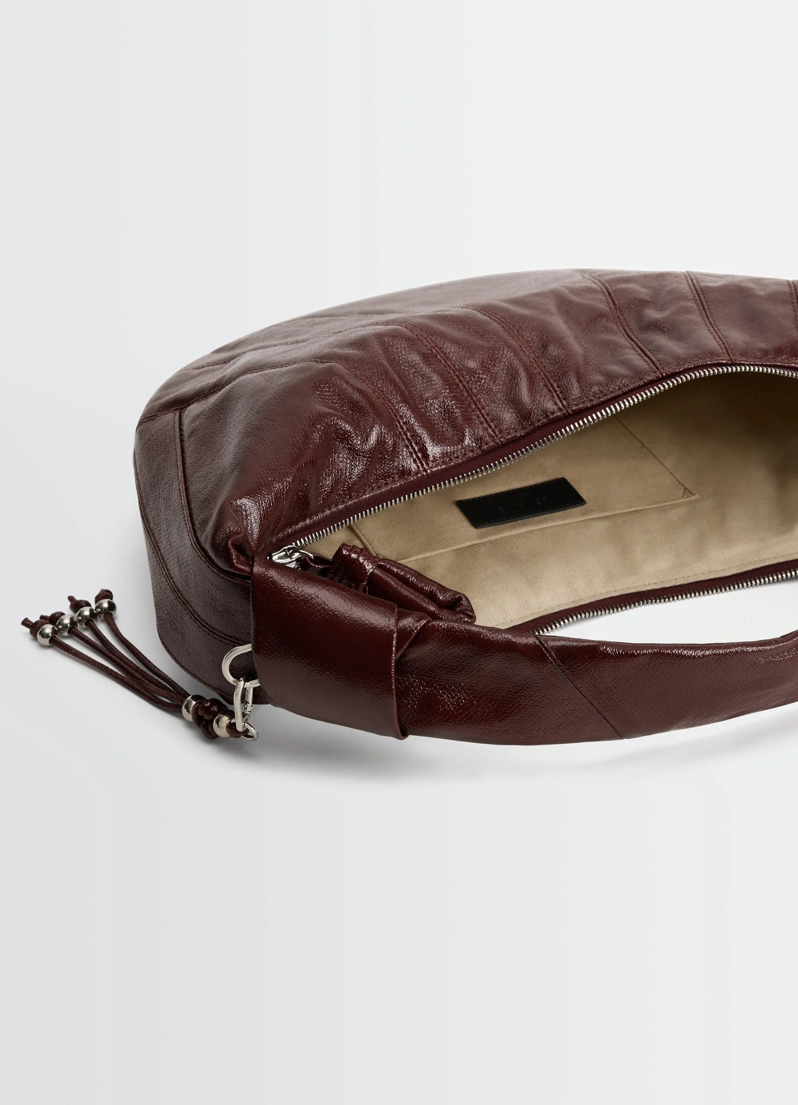 Lemaire fortune croissant bag in coated cotton canvas, product shot, top inside view zip closure, inner pocket