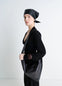 Lemaire Small Scarf Extended Handle in Black Nappa Leather, model shot, Side view Twisted shoulder strap