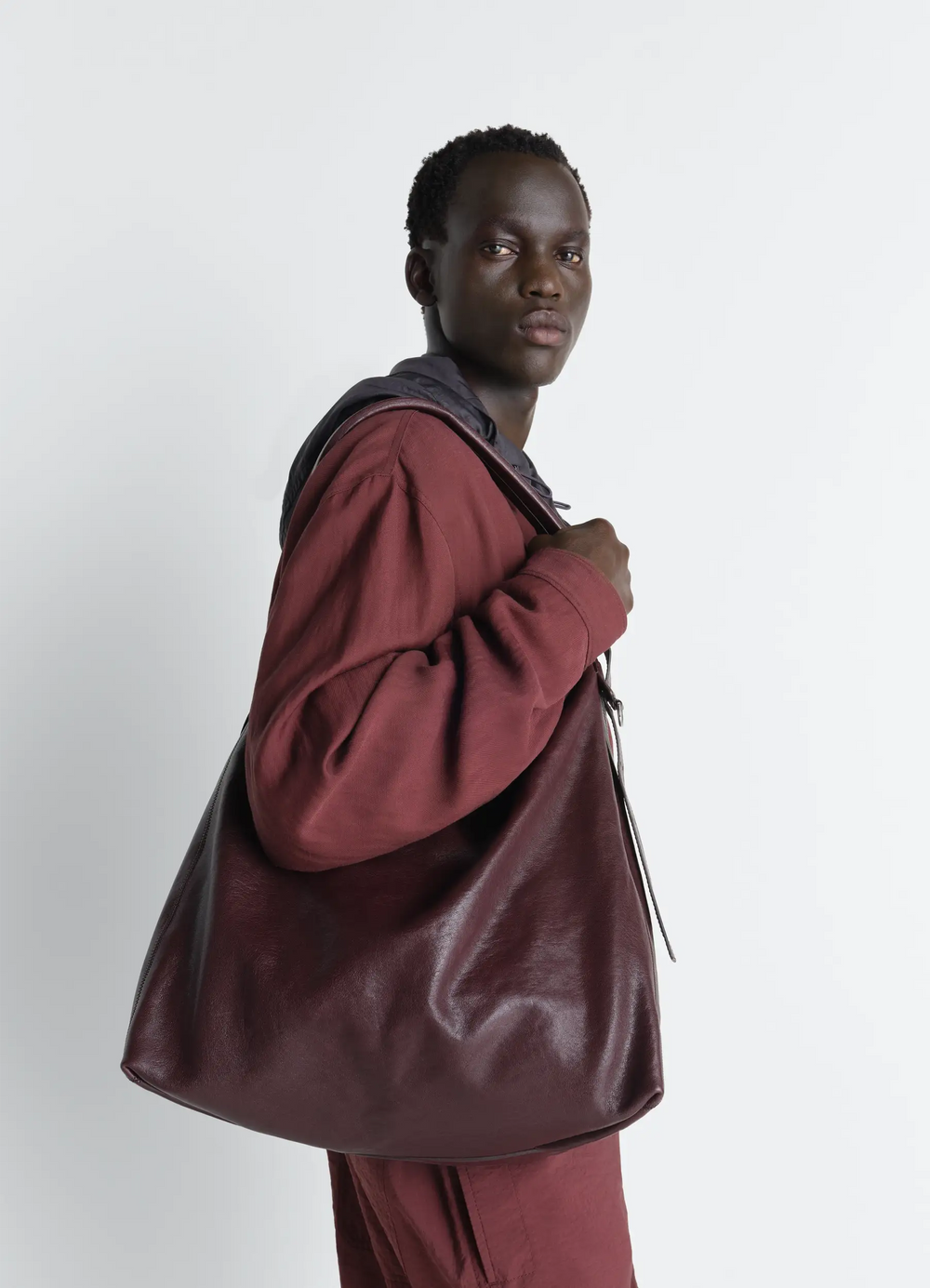 Belted Hobo Bag in Leather in Glazed Paper Leather, model shot, side view casual draped look