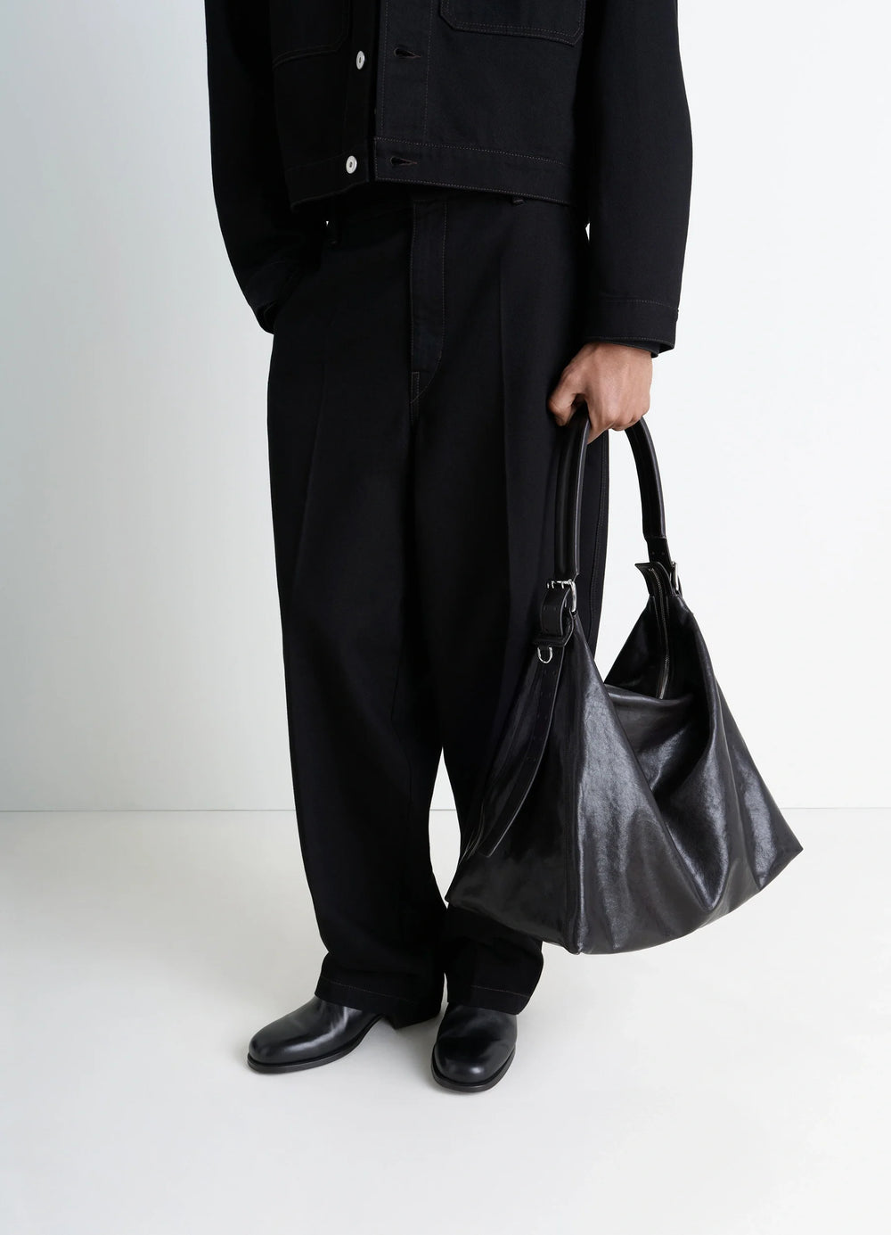 Belted Hobo Bag in Glazed Paper Leather, model shot, Side view Minimalist, utilitarian