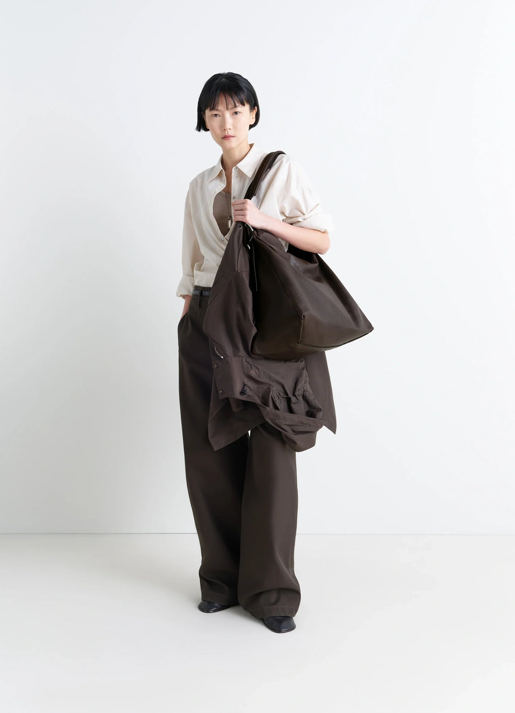 Belted Hobo Bag in Glazed Paper Leather, model shot, three-quarter view oversized relaxed fit