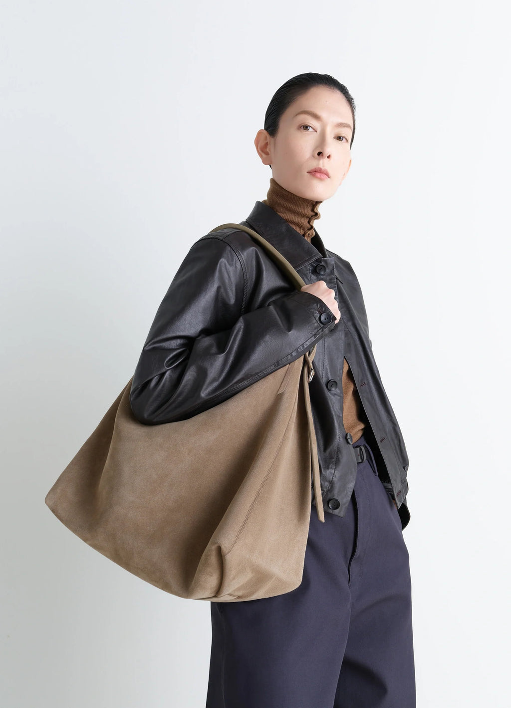 Belted Hobo Bag in Warm Textured Suede, model shot, Side view Minimalist utilitarian