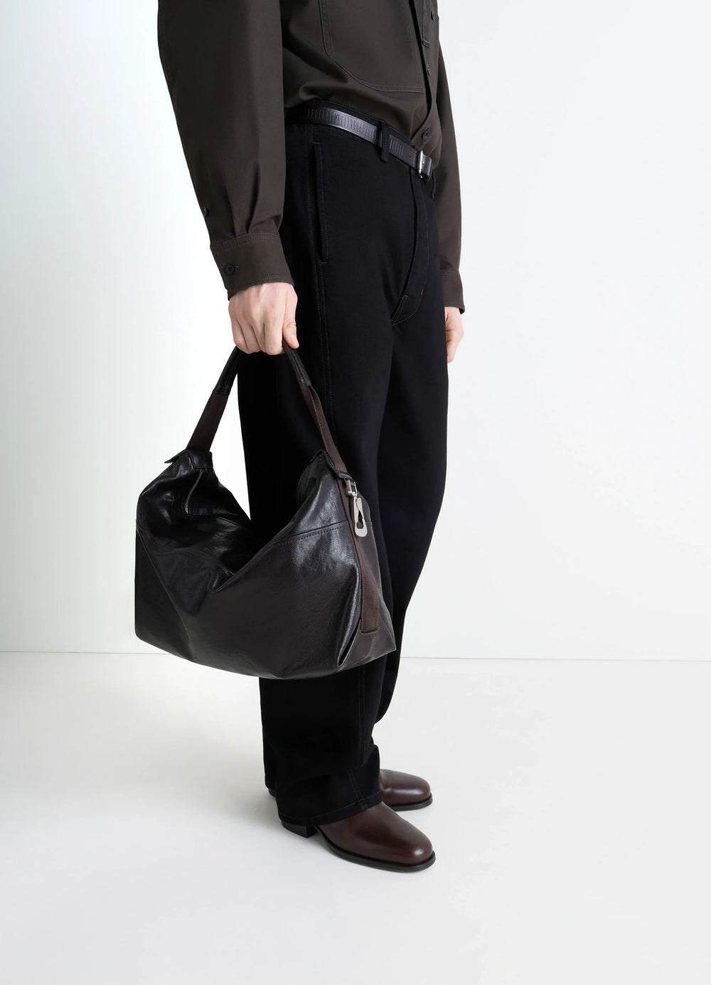 Berlingot Hobo Bag in Glazed Paper Leather, model shot, hand-held perspective glossy finish visible