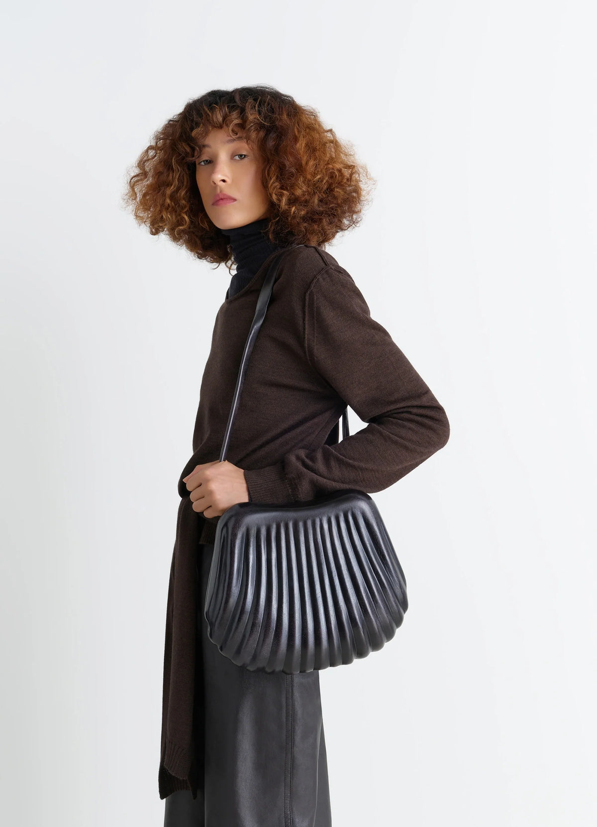Carlos Bag in Patinated Vegetable-Tanned Leather, model shot, Side view Cross-body styling