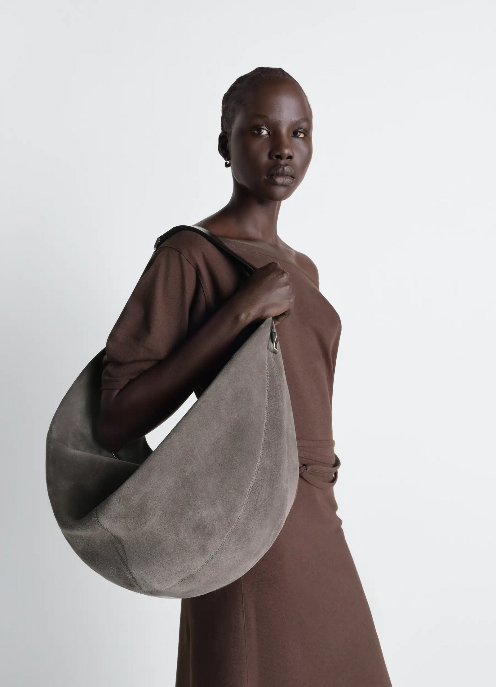 Lemaire large quiver clip bag in suede leather, model shot, side view slouched shoulder wear