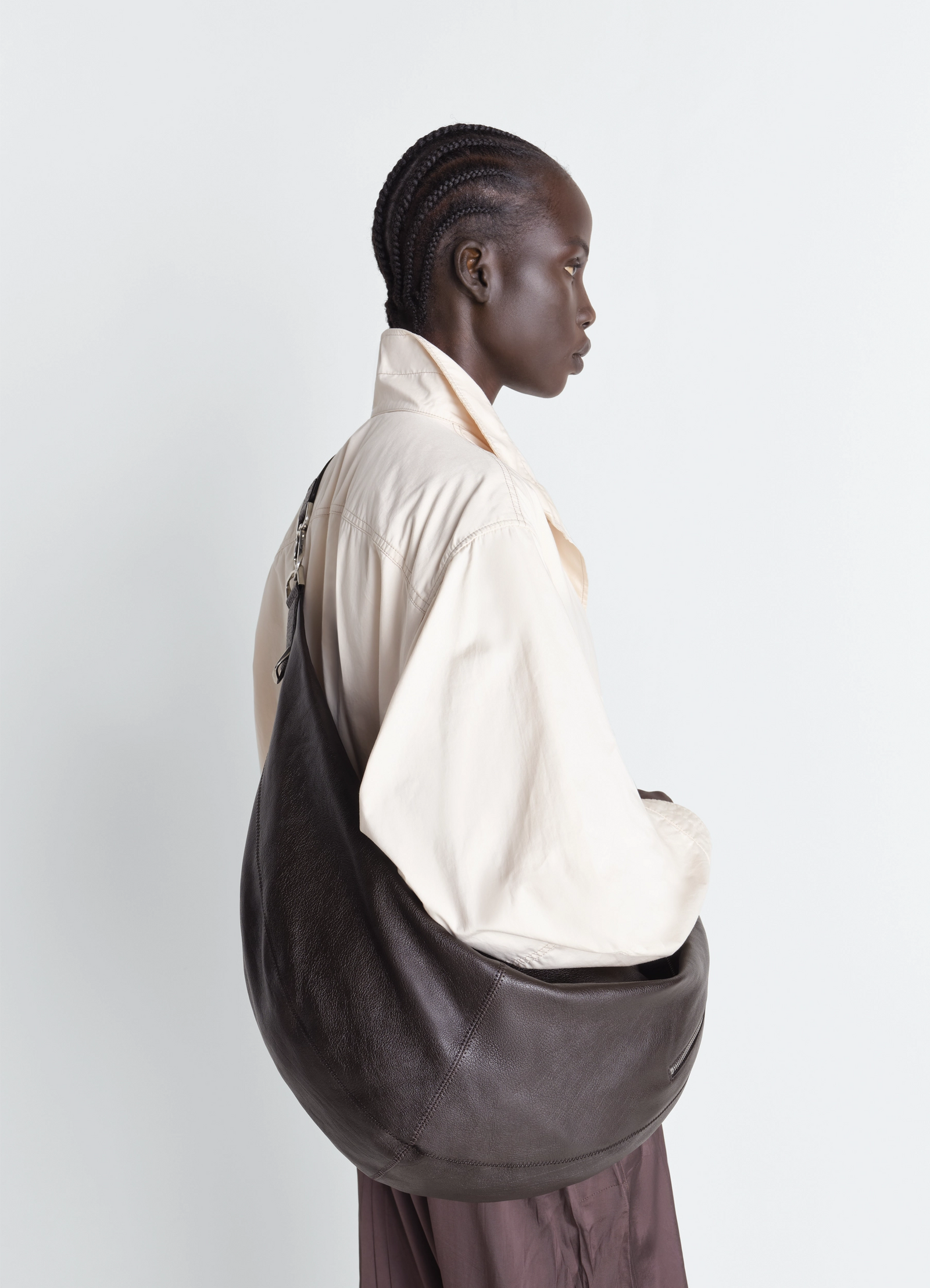 Large quiver clip bag in grained buffalo leather, model shot, side view slouchy curved shape