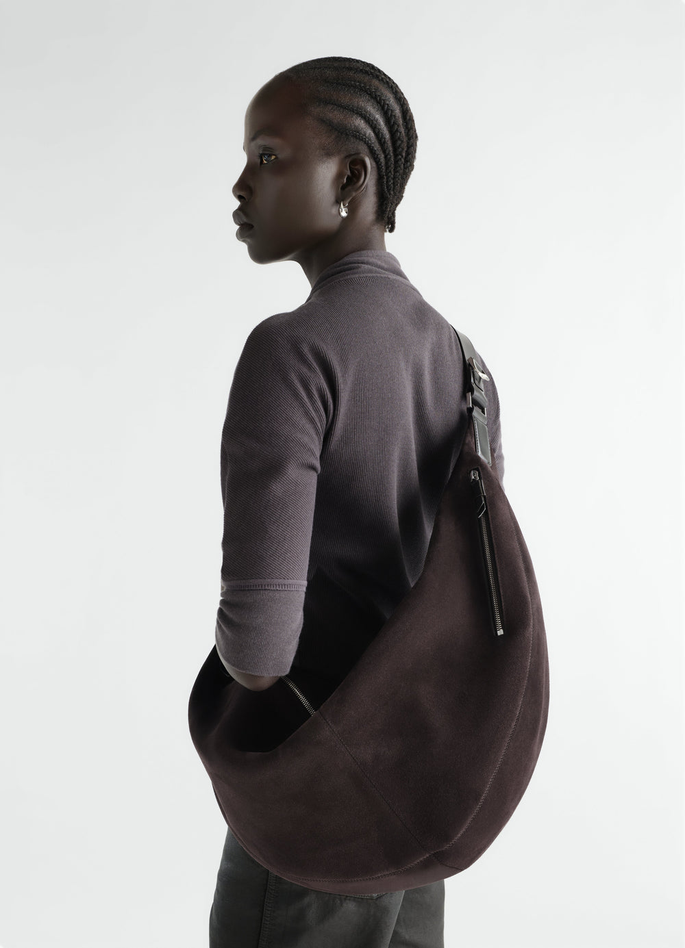Large Quiver Clip Bag in dark brown suede leather worn by model side view LEMAIRE