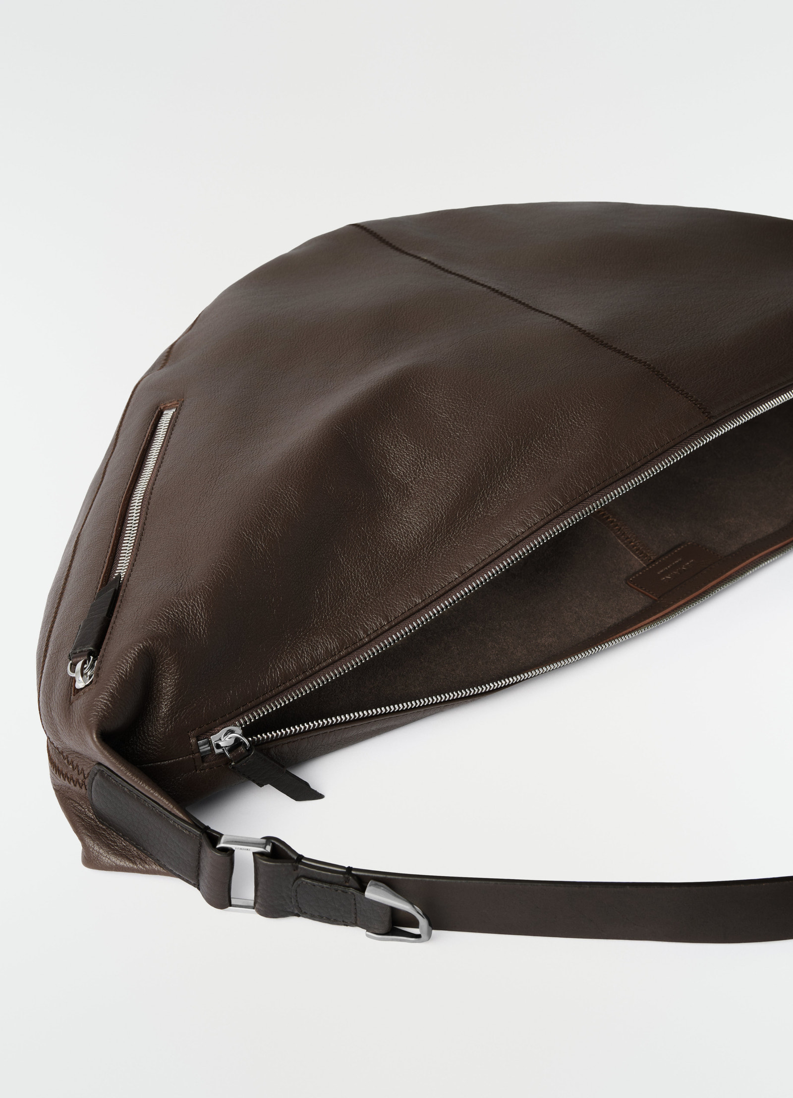 Large brown leather quiver clip bag by lemaire with silver zipper detail, shown close-up flat on white background