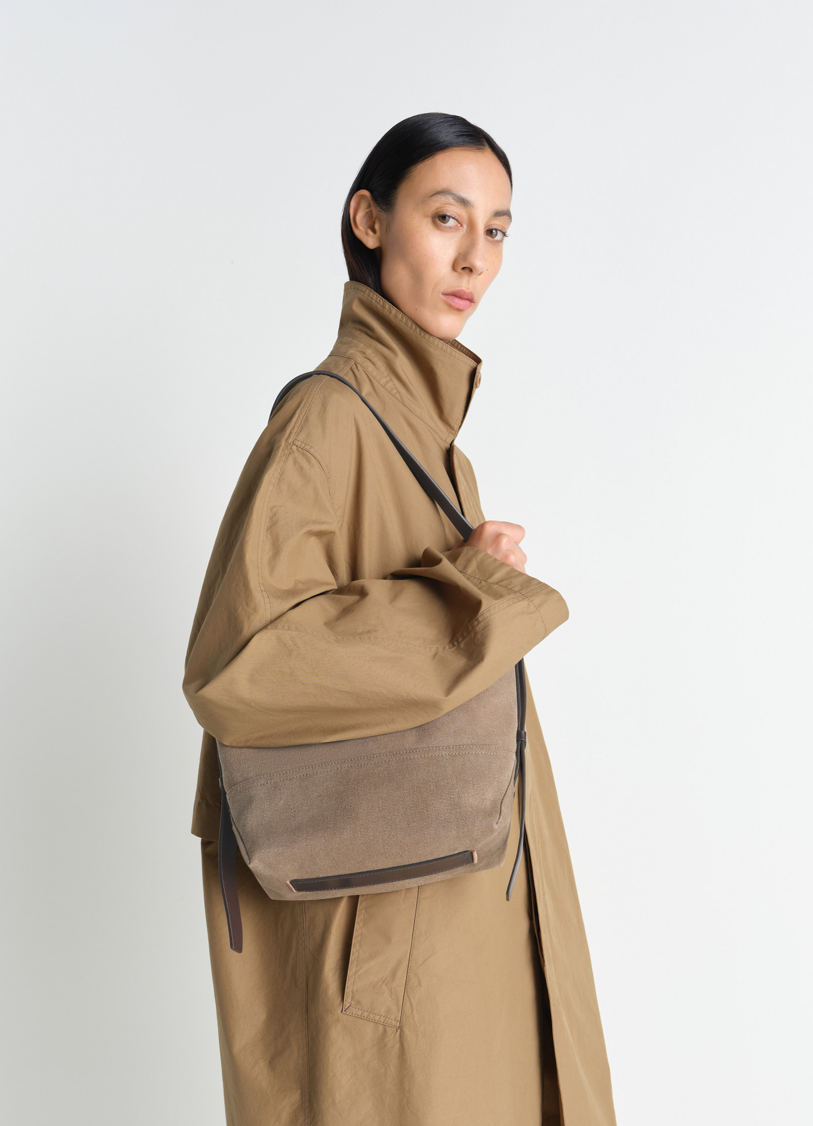 Small belted tote bag in cotton canvas, model shot, over shoulder view sling strap detail
