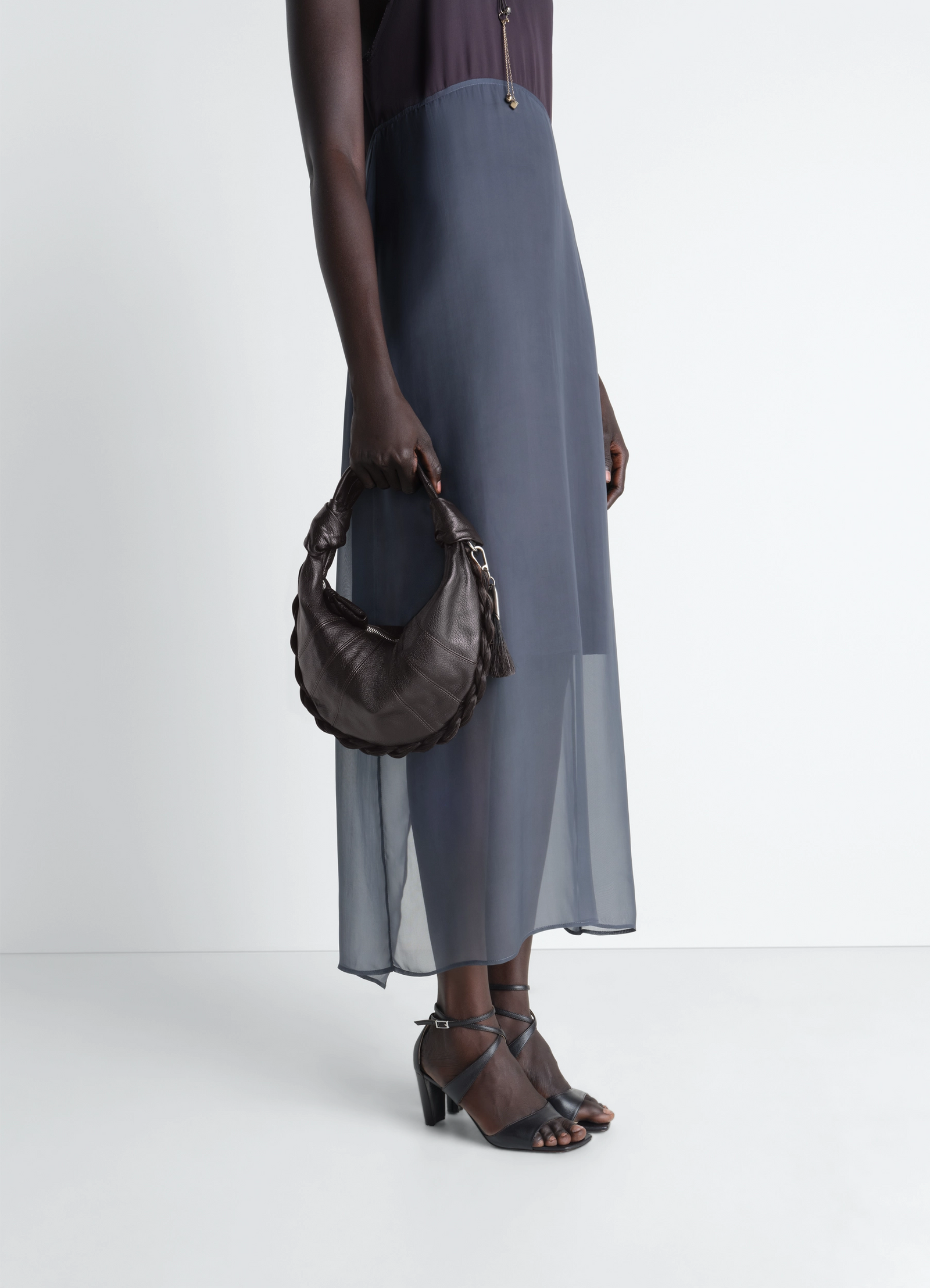 Mini fortune croissant bag in leather and horsehair, model shot, side view twisted handle