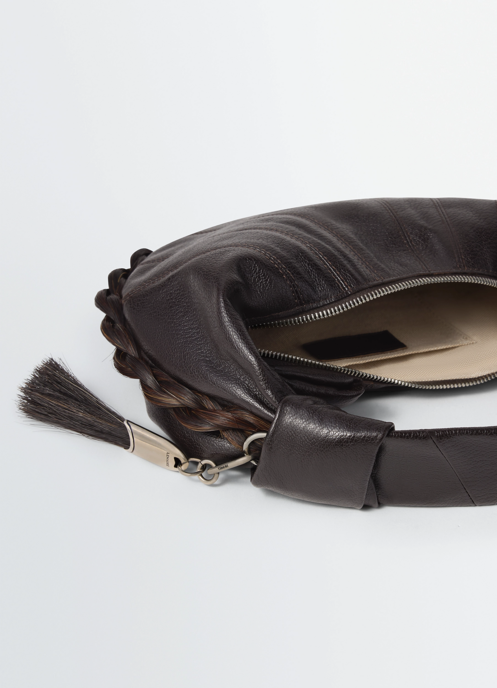 Mini fortune croissant bag in leather and horsehair, product shot, top detail shot tassel zipper closure