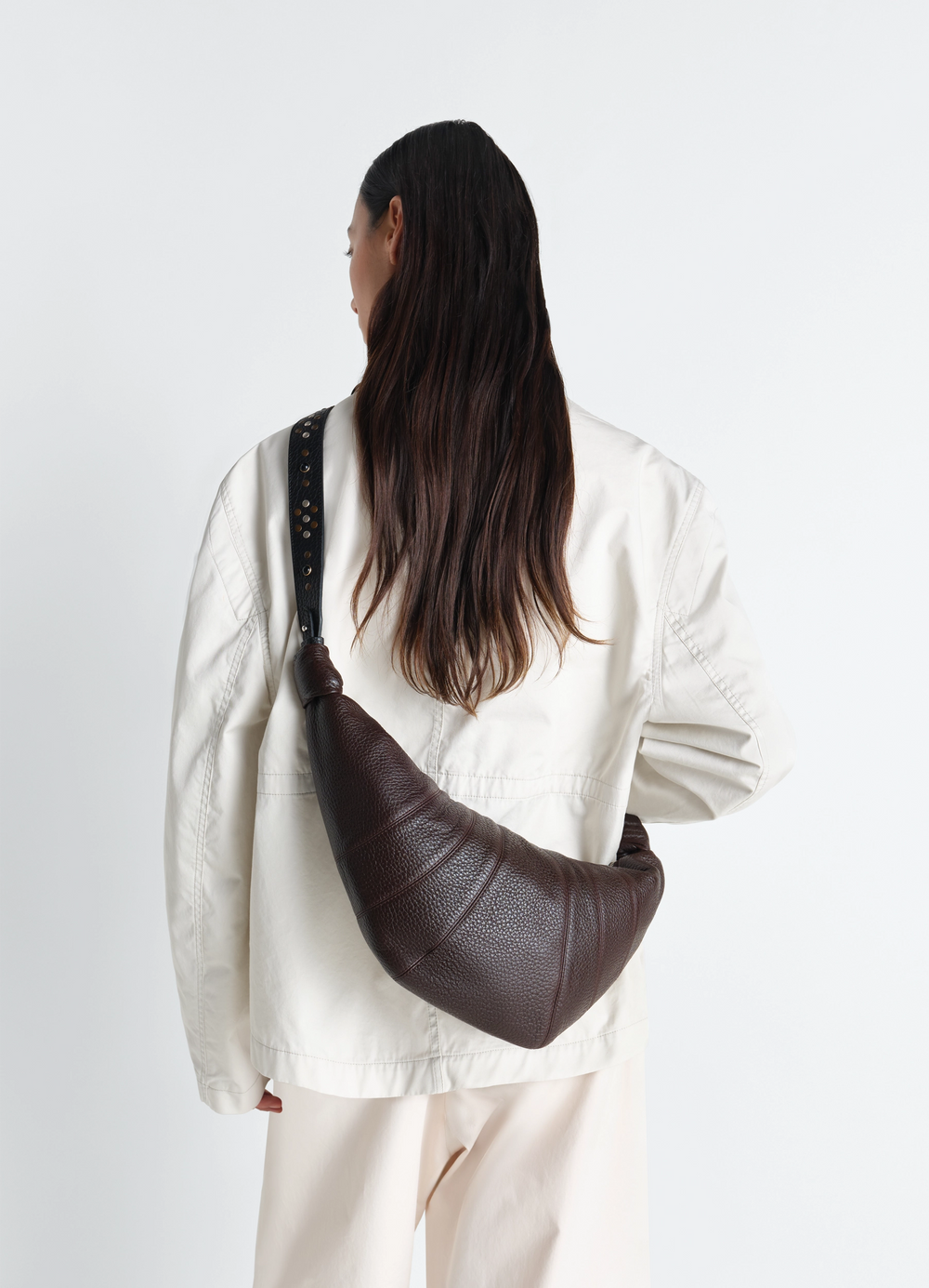 Western Studs Medium Croissant Bag in Grained Leather, model shot, back view carried over shoulder
