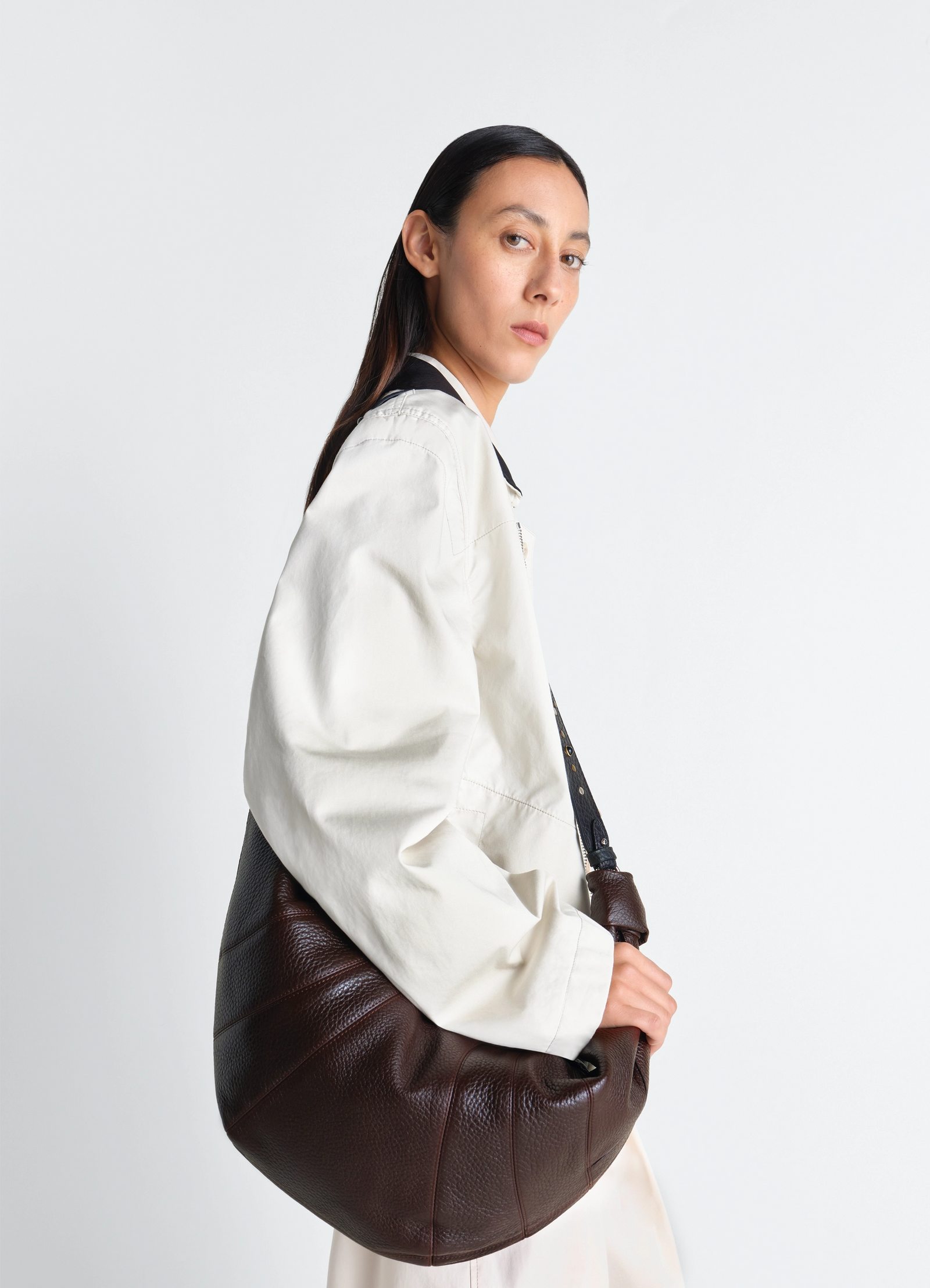 Western studs large croissant bag in leather, model shot, side view slouched silhouette